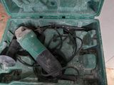 a green case with tools inside of it on the floor