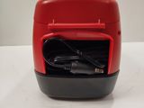 a red and black device sitting on a white table