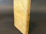 an old book sitting on top of a table with a black background