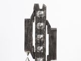 sculpture of a metal object on a white pedestal against a white background