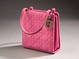a pink purse that is sitting on a table