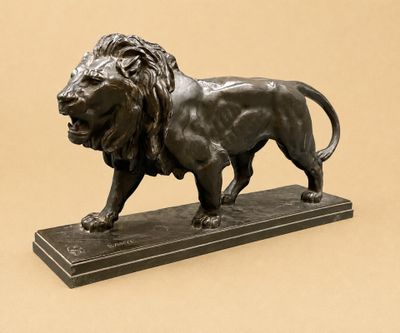 bronze statue of a lion on a marble base on a beige background