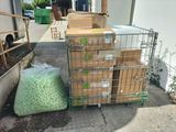 many boxes of food sitting on a cart outside