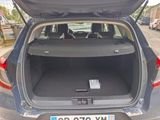 the back of a car with its trunk open on a city street