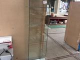 a glass display case with a red light on top of it