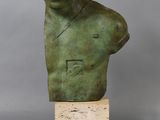 a bronze busturine of a man with a hat on his head