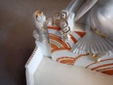 a figurine of a woman and a man on a boat