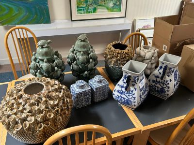 many vases sitting on a table in a room