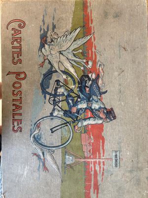 a person holding up a book with a picture of a bird on it