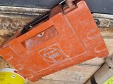 an orange tool box sitting on top of a wooden floor next to other tools