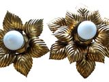 pair of gold and white flower earrings with pearls on them
