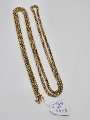 a close up of a gold chain with a tag on it