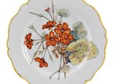 a plate with flowers painted on it on a white background