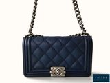 the chanel bag is blue and has a chain strap