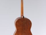an acoustic guitar hanging from the ceiling