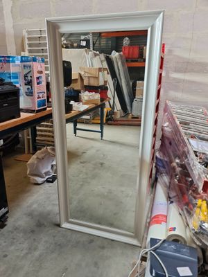 a large mirror sitting in the middle of a room