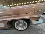a car that is parked in a garage with its hood up