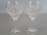 two wine glasses that are sitting on a table