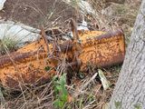 an old rusted piece of metal sitting in the grass