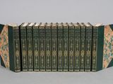 six books in a row with green covers and gold designs