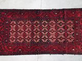 a close up of a red rug on a white floor