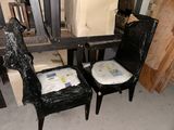 two chairs that have been painted black and covered in plastic