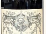 a bottle of wine sitting on a table next to a bottle of wine