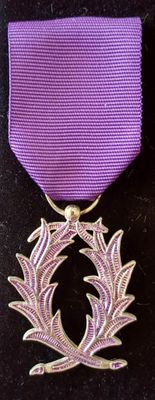 ruban violet orné d'une couronne argentée, sur un fond noir