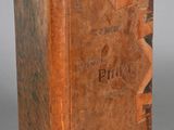 an old book sitting on top of a table next to a white wall