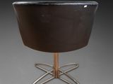 an image of a black chair with a metal base on a grey background