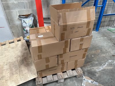 a stack of cardboard boxes on a pallet in a warehouse