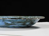a blue bowl sitting on top of a white table