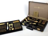 a black case with silverware in it on a white surface