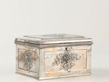 an image of a silver box with a flower design on the lid