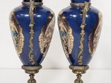pair of blue and gold vases sitting on top of a table