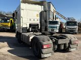 a truck that is parked in a lot with other trucks in the background