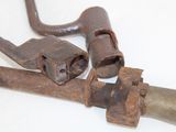 two old rusted pipe wrens on a white surface
