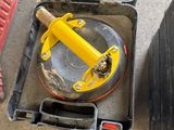a tool box with a yellow handle and a tool in it