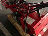 a red machine that is sitting on top of a pallet
