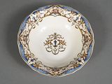 a close up of a white bowl with blue trim and gold decoration