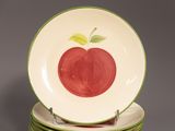 several plates with apples painted on them stacked on top of each other