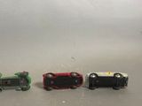 three toy cars sitting next to each other on a table