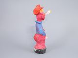 a figurine of a woman with a red hat and a blue dress