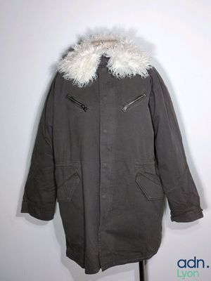 an image of a coat with a fur collar on a mannequin stand