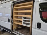 a white van that has some shelves inside of it