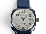 a close up of a watch on a white surface