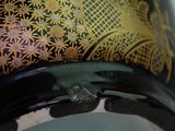 a close up of a vase with a clock on it
