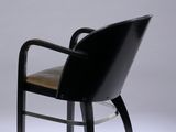 a black chair with a wooden seat on a white background
