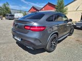 the rear end of a grey mercedes suv parked in a parking lot