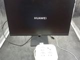 a picture of a computer monitor and a charger on a table